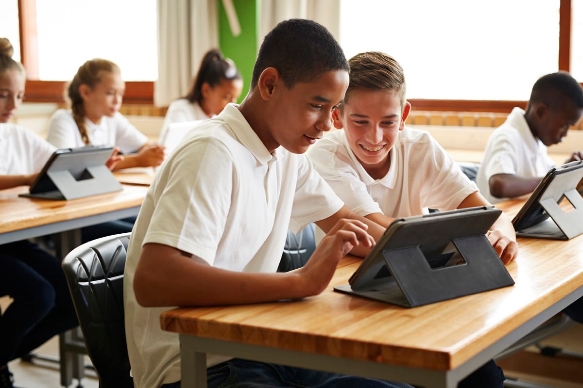 Image of teacher helping a student 