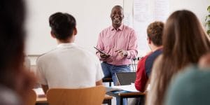 Professor engaging with students in a discussion. 