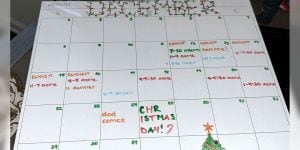 A large paper desk calendar from December 2024 with events noted on various days.