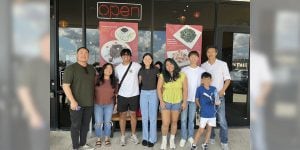 Blog author Jocel, 3rd from the left, is pictured with his family outside a restaurant.