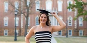 Blog author Madison wearing a graduation cap in front of a campus building.