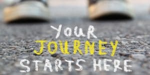 A photograph of feet in sneakers with the words "your journey starts here"