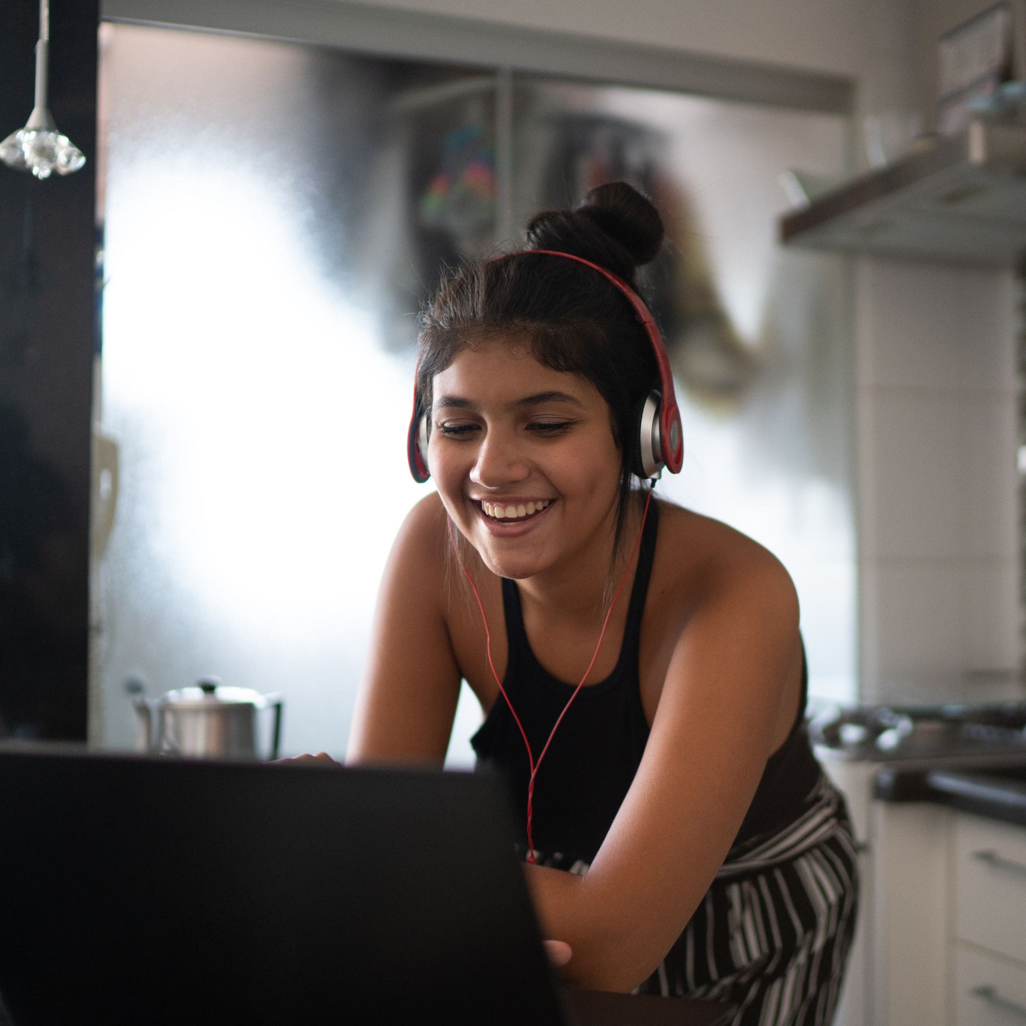 Student laughing while looking at laptop