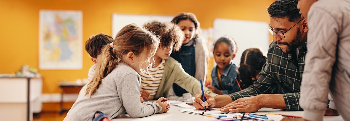 Teacher and primary school students colouring