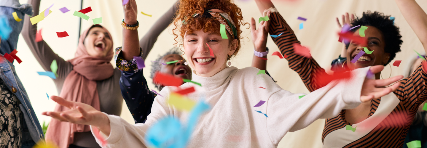 A group of women celebrating with confetti