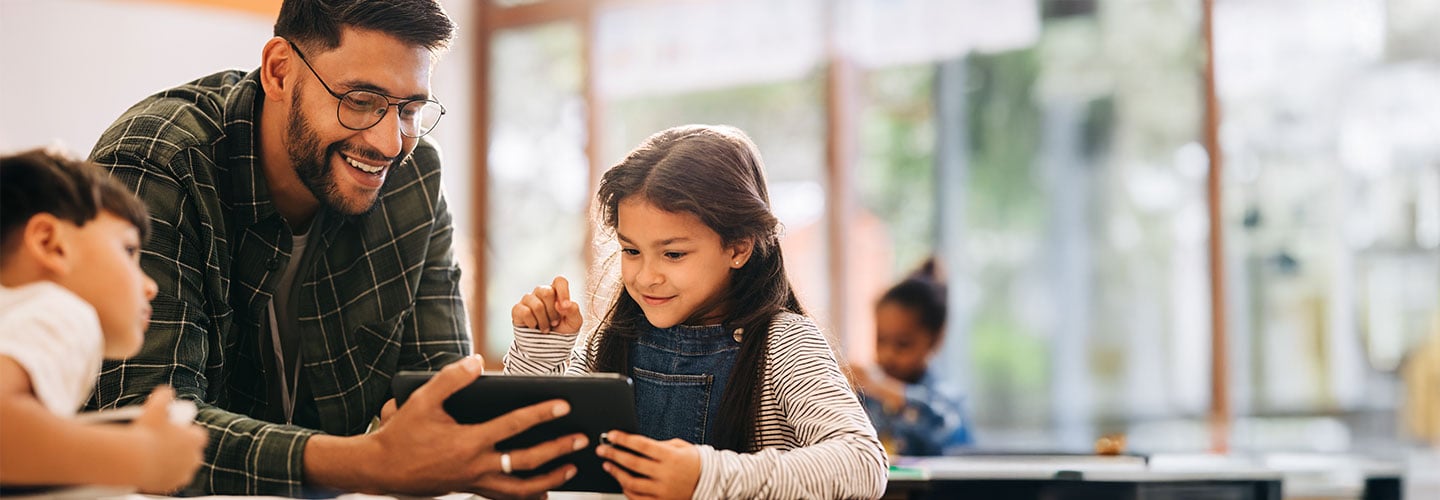Teacher with pupil looking at a tablet