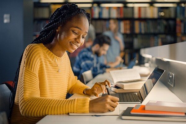 Student works on laptop in library